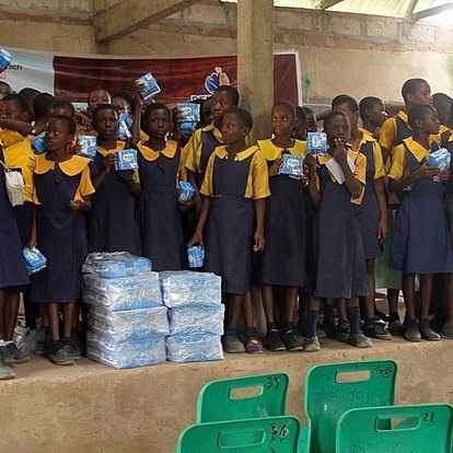 School girls standing beside sanitary pads during an outreach